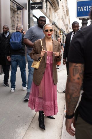 Doja Cat in a nearly-naked corset dress while shopping in Paris, France.