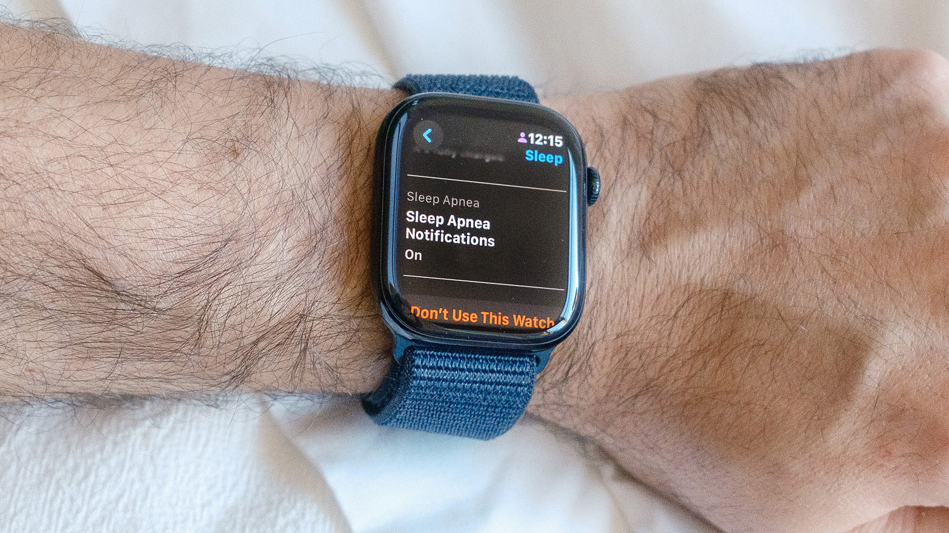 Close-up of an Apple Watch 10 on a user's wrist with the screen showing that the sleep apnea safety feature is switched on