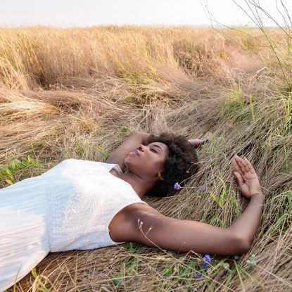 Cut grass perfumes - woman lying in grass field