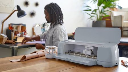 How to make money with Cricut, a photo of a man using a Cricut