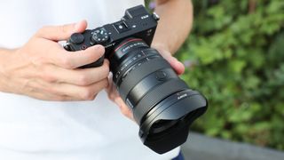 Sony A7C II camera with Sony FE 16-35mm f/2.8 GM II lens being held by DCW reviewer