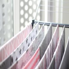 Hanging towels on a clothes airer to dry