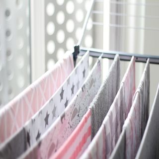 Hanging towels on a clothes airer to dry