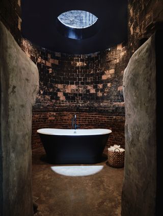 Bath at Bathhouse spa in Williamsburg Brooklyn with black bath in titled room with skylight