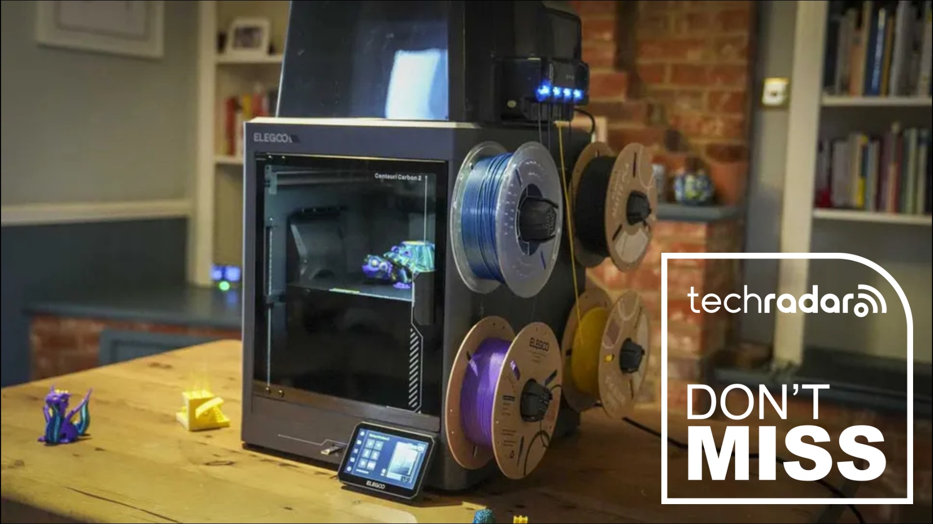 The Elegoo Centauri Carbon 2 Combo 3D printer during our testing, with a white TechRadar badge that reads 'Don't Miss' in the lower right corner