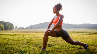 Women lunges outdoors in workout gear
