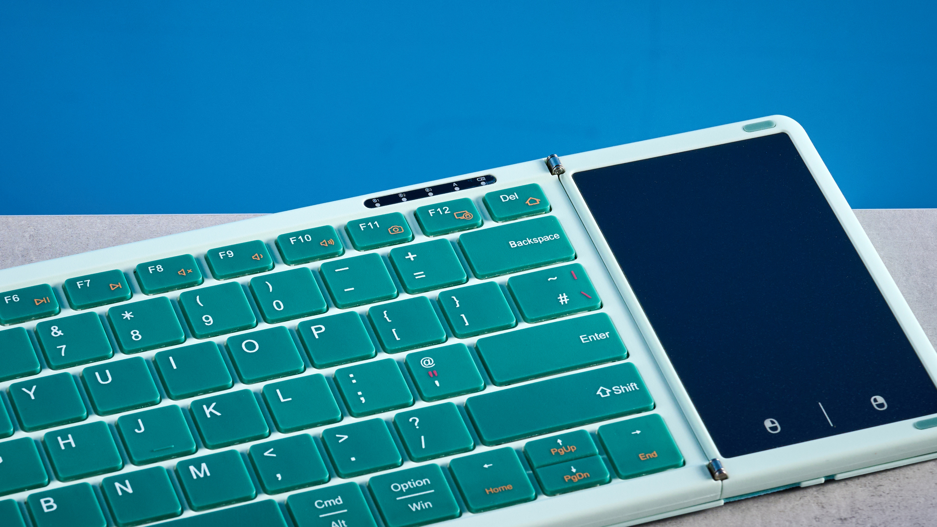 Seenda Foldable Bluetooth Keyboard with Touchpad pictured in front of a blue background.
