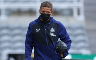 Newcastle United striker Dwight Gayle arrives at St. James' Park wearing a mask and carrying a wash bag