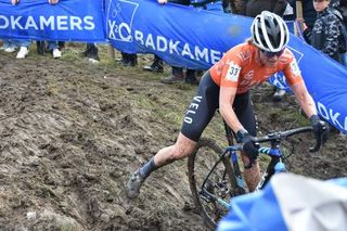 Corey Coogan-Cisek racing in the mud in Ruddervoorde in 2021