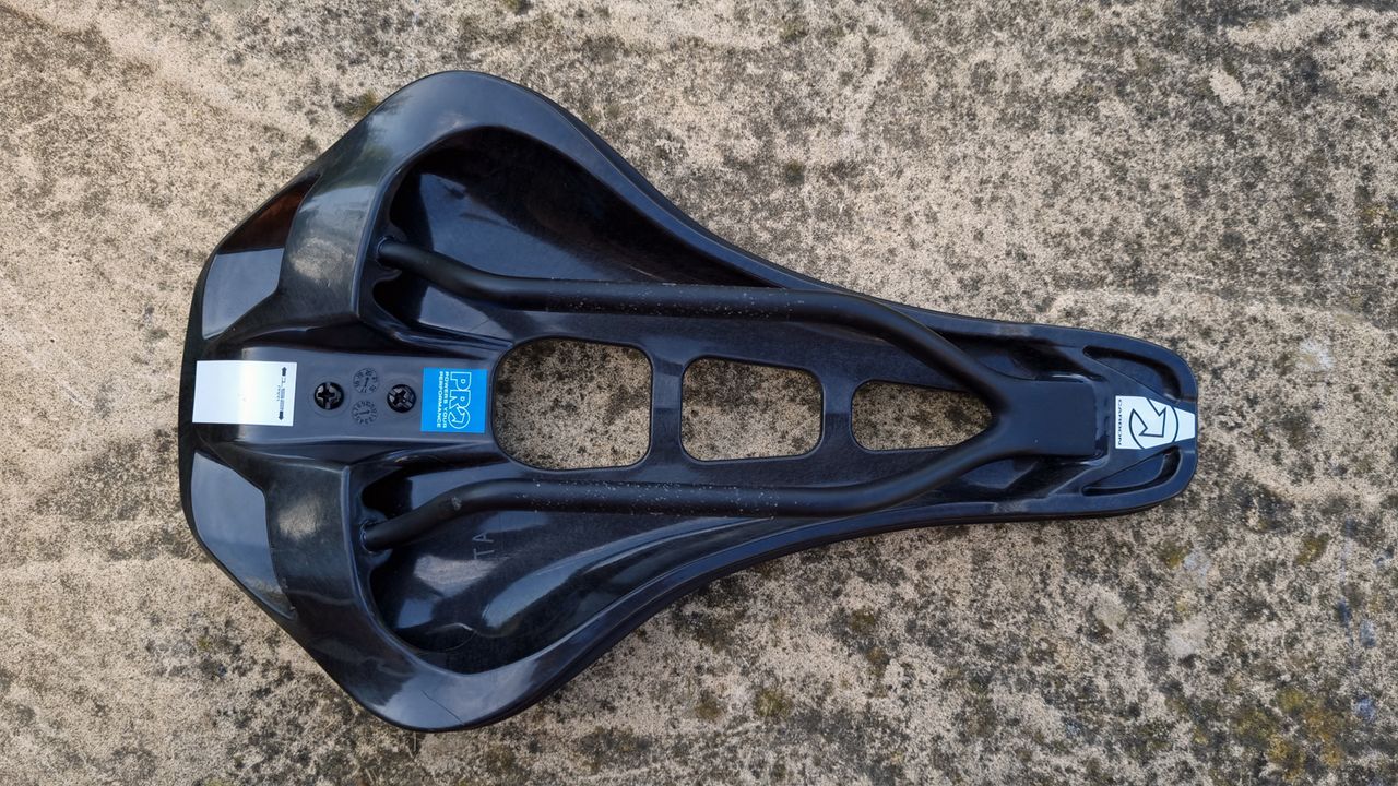A close up of the Pro Stealth Carbon Saddle on a stone floor