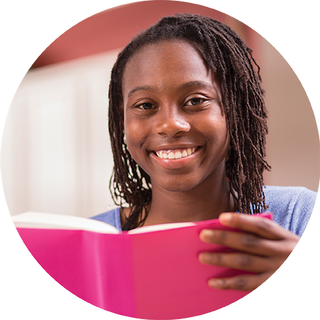 Image of young girl reading a book with a pink cover