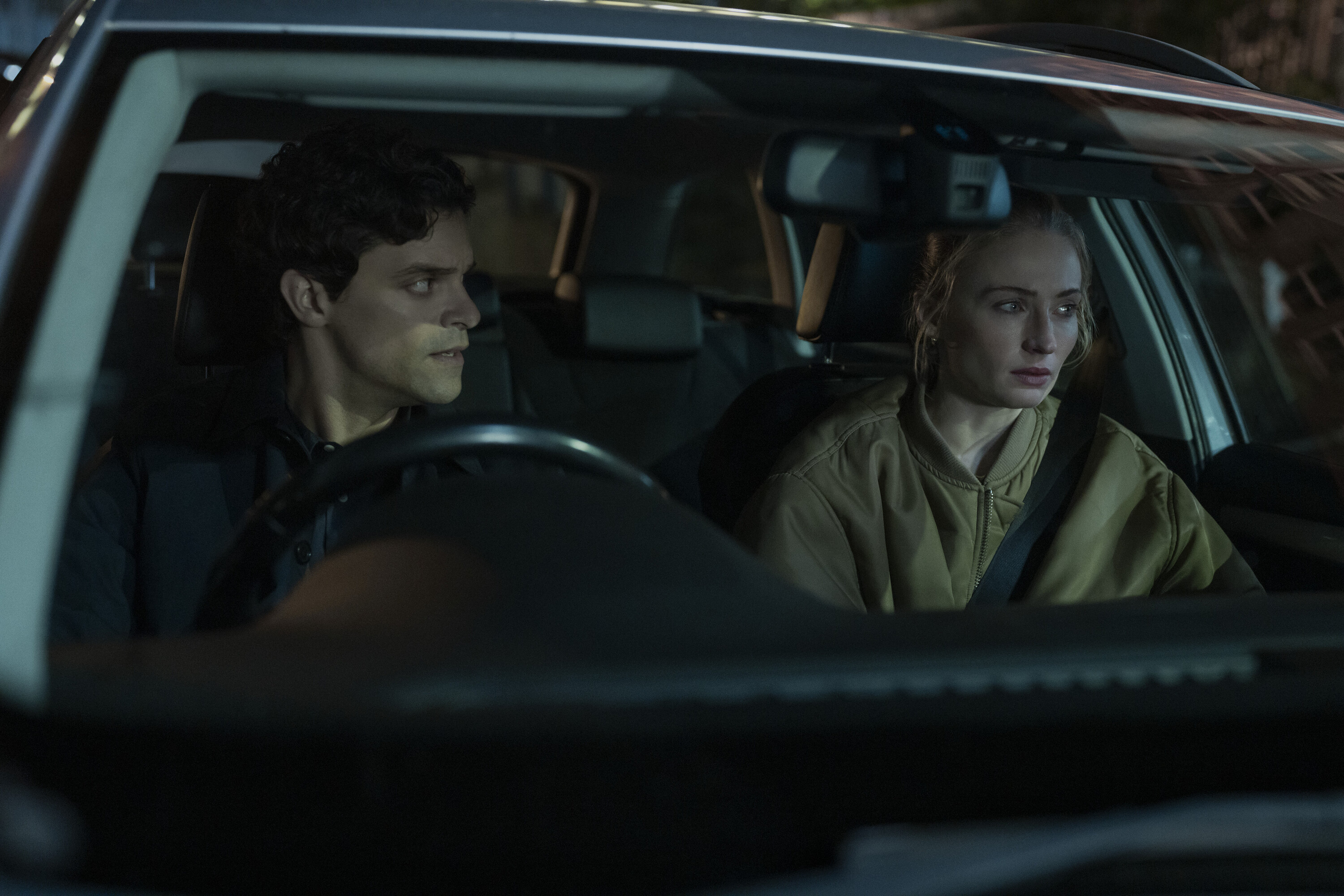 jacob fortune lloyd as rhys and sophie turner as zara in a car together at night looking concerned in a still from steal