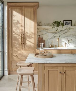 japandi neutral and wood kitchen with marble backsplash