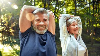 a middle aged man and woman stretching