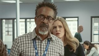 Greg and Collette looking off worriedly in DMV Season 1