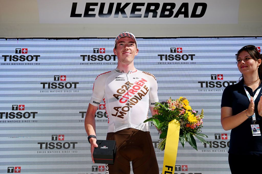 LEUKERBAD SWITZERLAND JUNE 14 Stan Dewulf of Belgium and Ag2R Citron Team celebrates at podium as most combative rider trophy during the 86th Tour de Suisse 2023 Stage 4 a 1525km stage from Monthey to Leukerbad 1367m UCIWT on June 14 2023 in Leukerbad Switzerland Photo by Dario BelingheriGetty Images