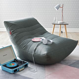 grey lounger with headphones and lamp