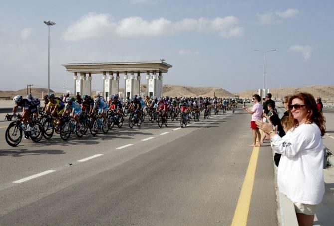 The peloton is cheered on during stage 2 of the Tour of Oman