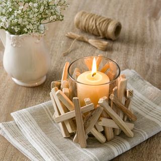 wooden table with flowers and lit candle