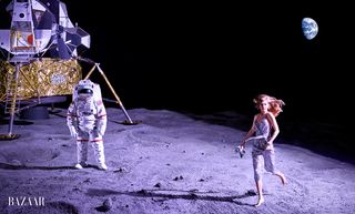 Supermodel Gigi Hadid walks across a mock moonscape with an Apollo astronaut and lunar lander nearby during a Harper's Bazaar photo shoot for the magazine's June/July 2017 issue.