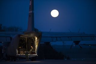 Airmen Prep Flight Under Full Moon