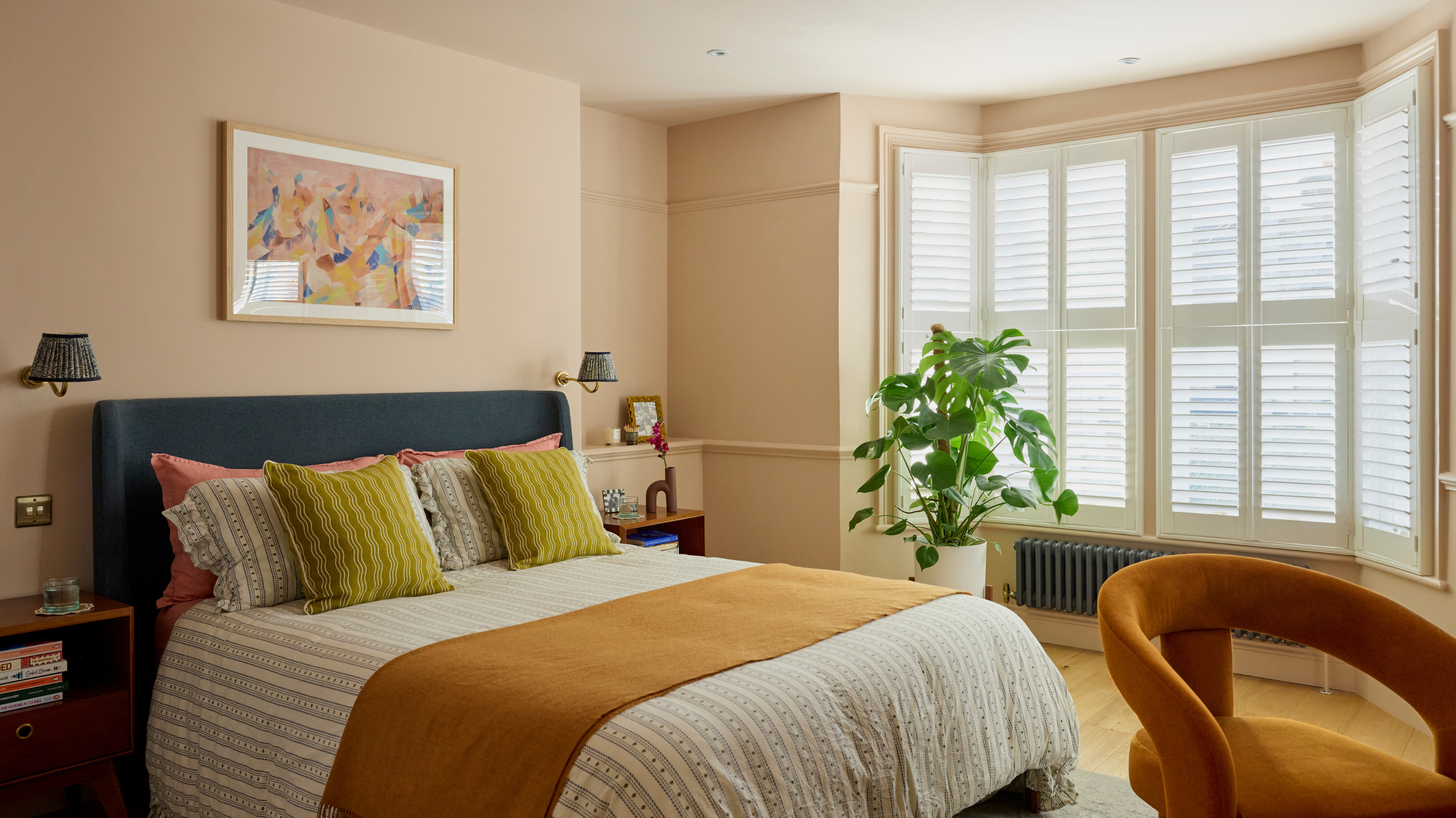 Blush bedroom with large bay window and blinds