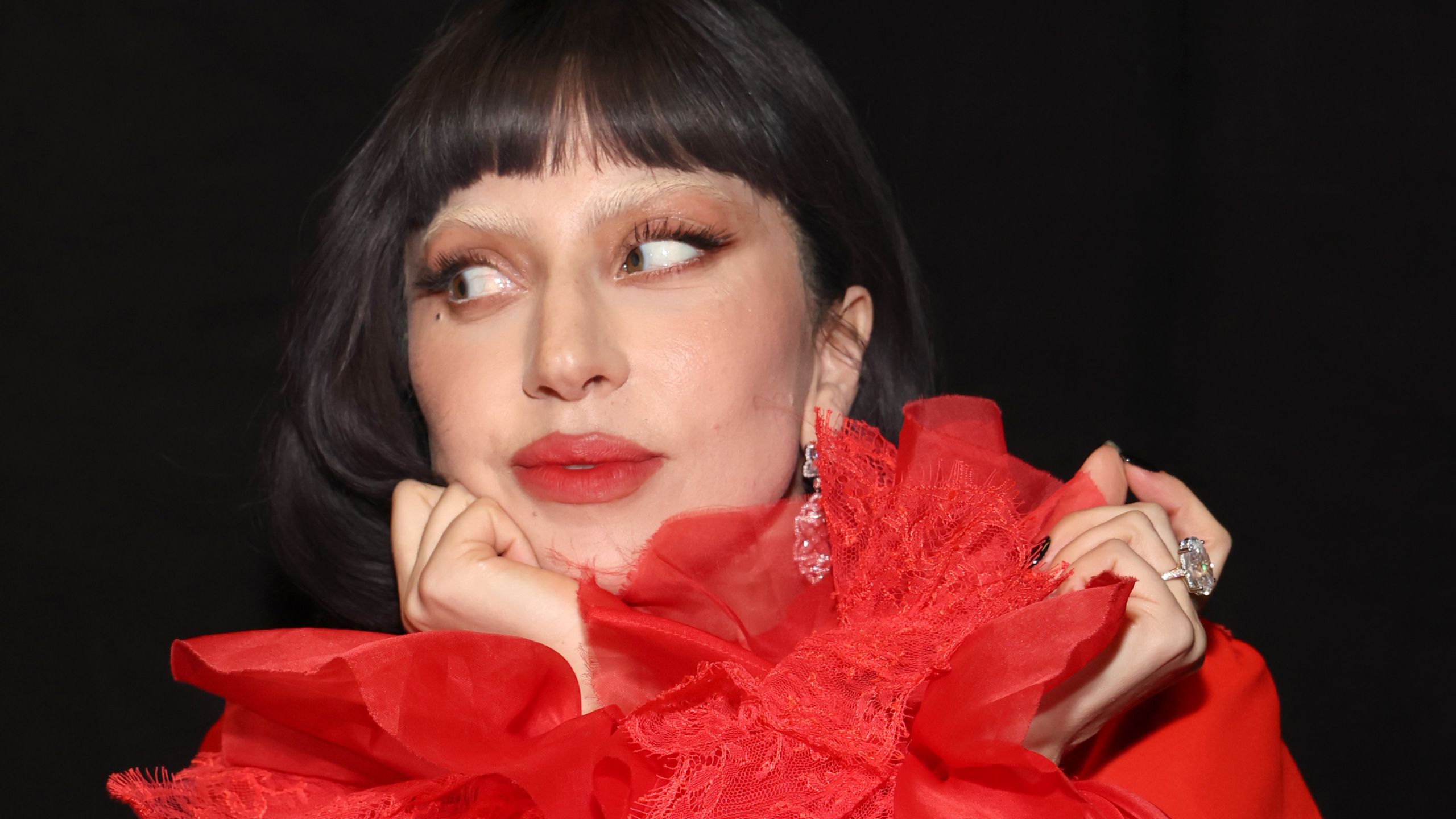 lady gaga in red on a black background