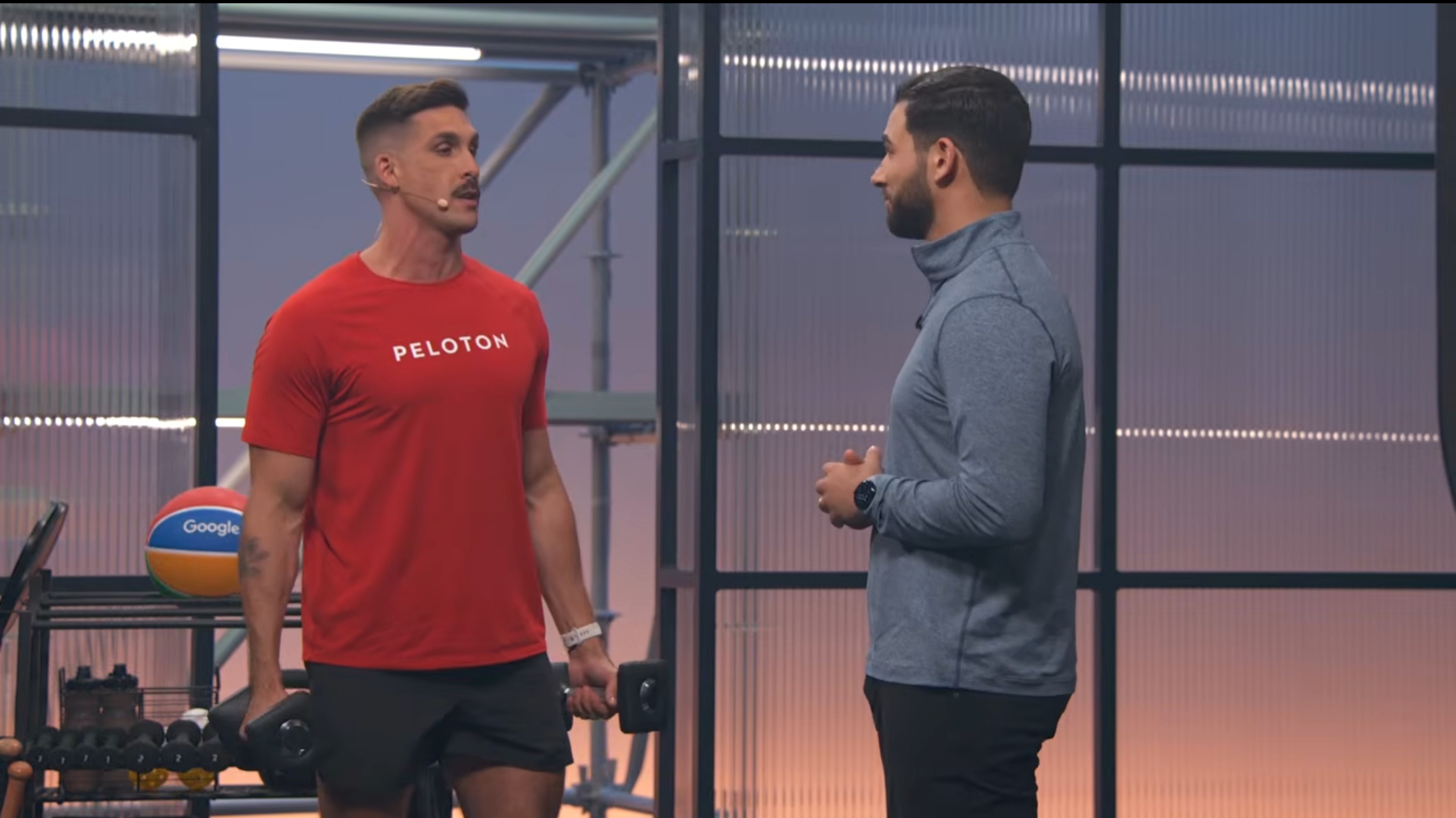 Two speakers demonstrating the improved weight lifting sensing capabilities of the Pixel Watch 4