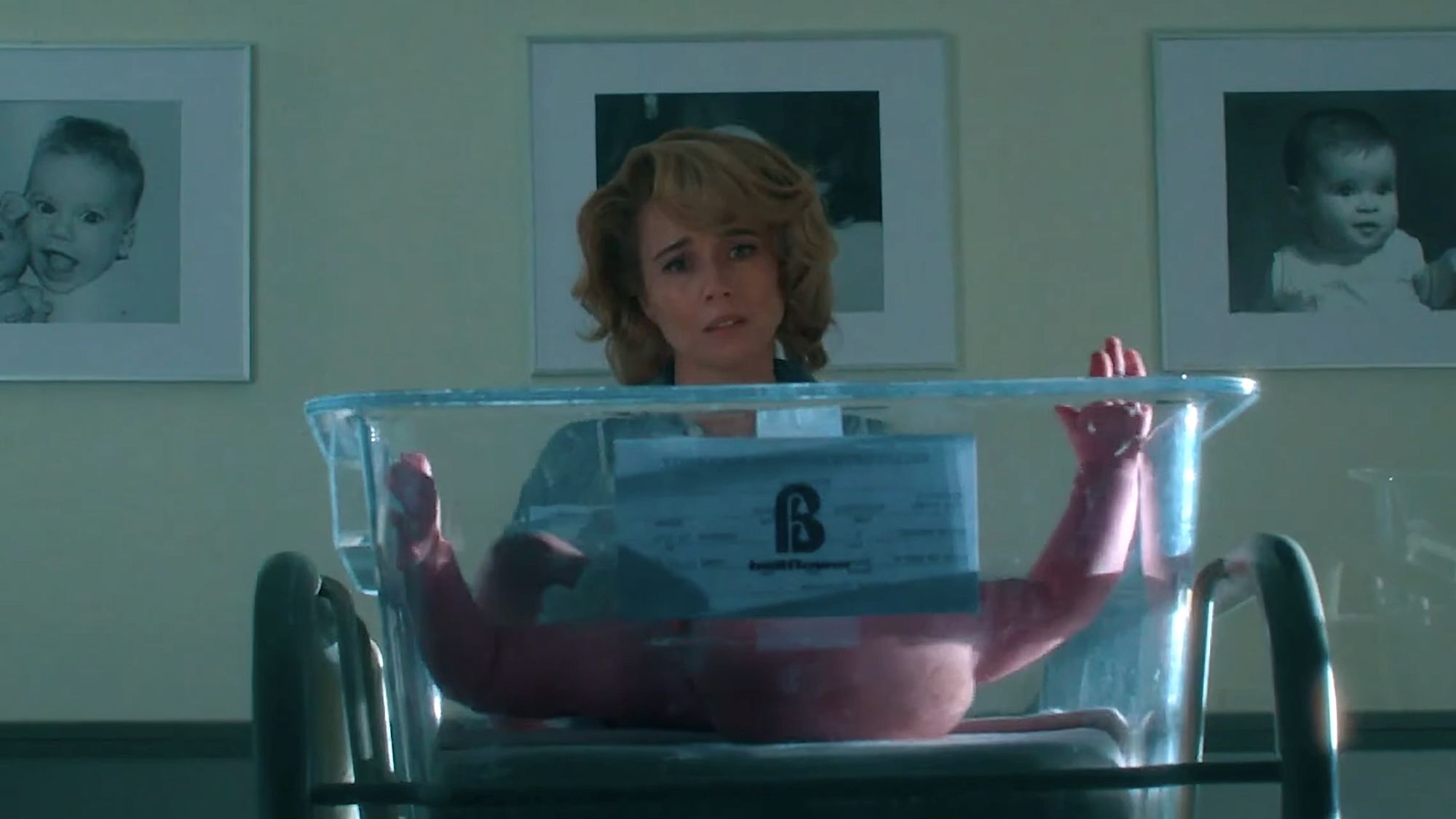 Pamela Voorhees looking down at a baby inside a nursery cart in Crystal Lake Season 1