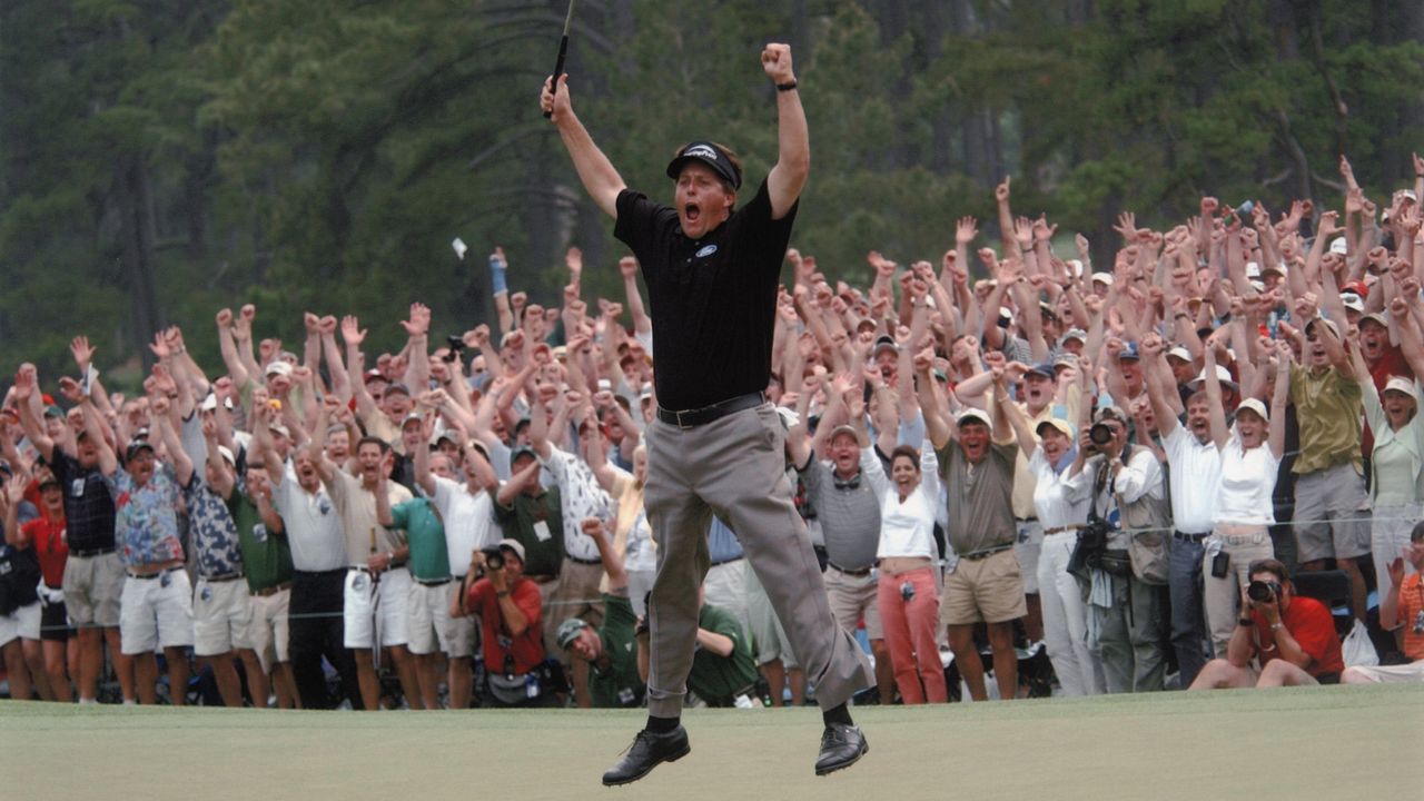 Phl Mickelson jumps in celebration after winning the 2004 Masters