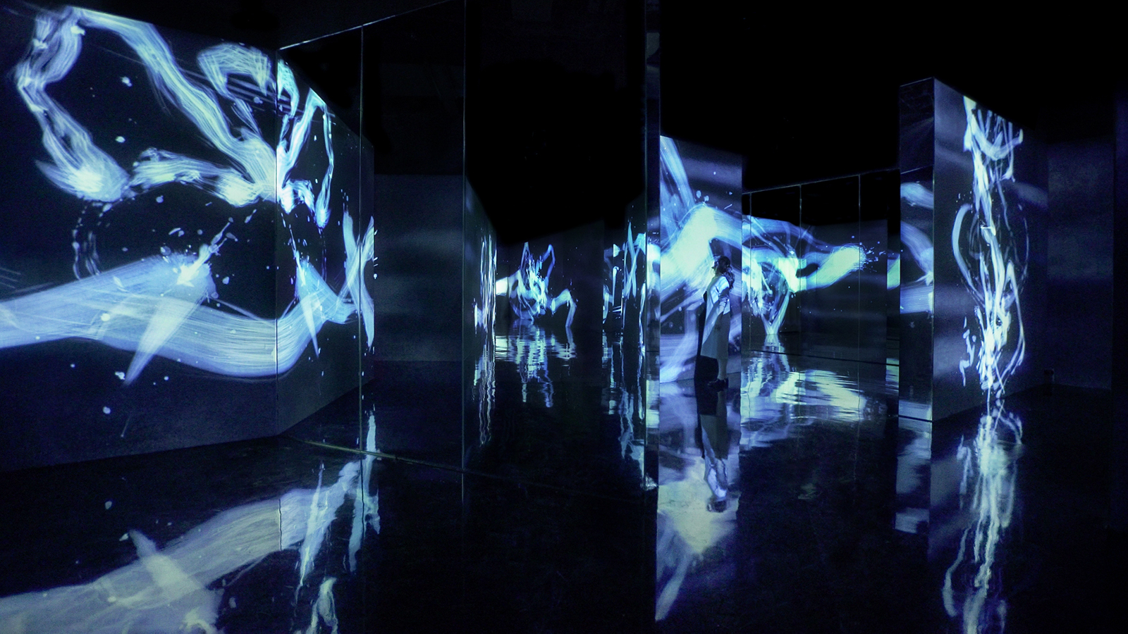 A room with blue streaks of light projected onto wall dividers