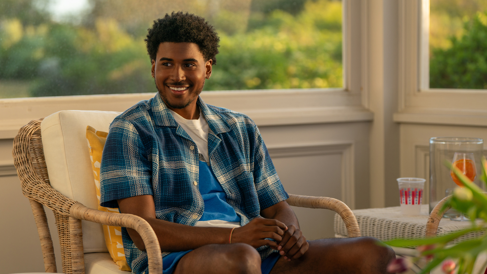 Michael Cooper Jr. as Justin Edwards, sitting in a wicker chair in a sunroom, in Episode 105 of Forever.