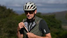 Tester Tim Russon unzipping his Q36.5 Adventure Cycling Vest on a sunny Fall Day. 