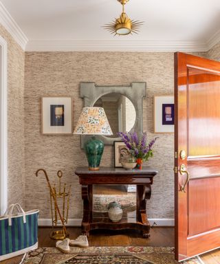 foyer with console table and table lamp front door open