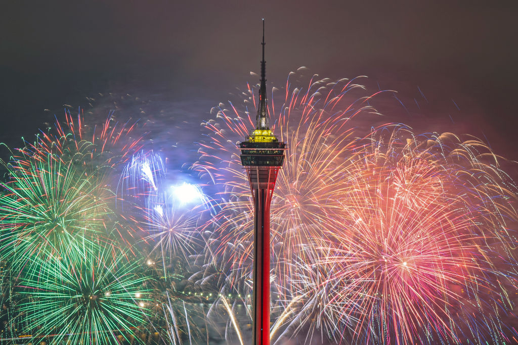 MACAO, CHINA - FEBRUARY 03: Fireworks explode over the sea area in front of Macao Tower to cheer for Olympic athletes and celebrate Chinese New Year on February 3, 2022 in Macao, China.