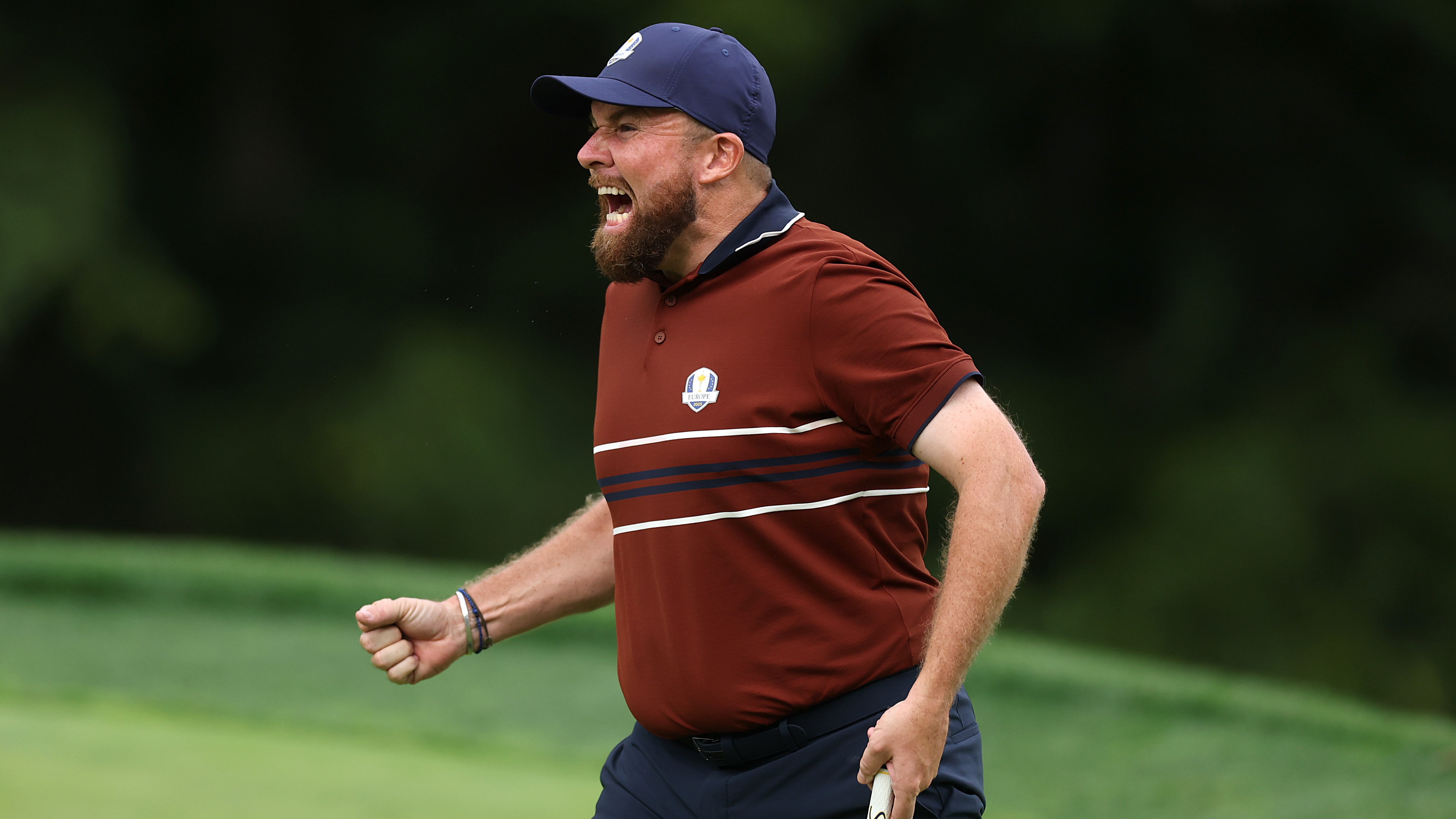Shane Lowry celebrates closing on the 15th green at the 2025 Ryder Cup.