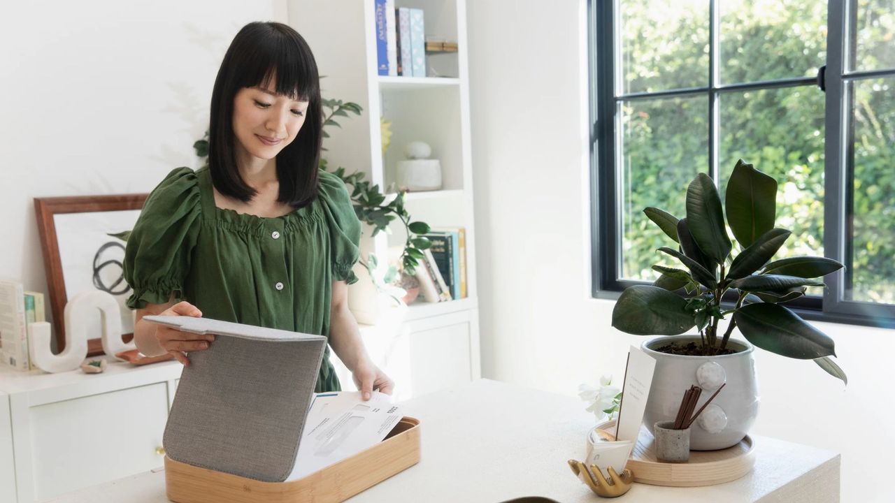 Marie Kondo organizing some paper in a bright room