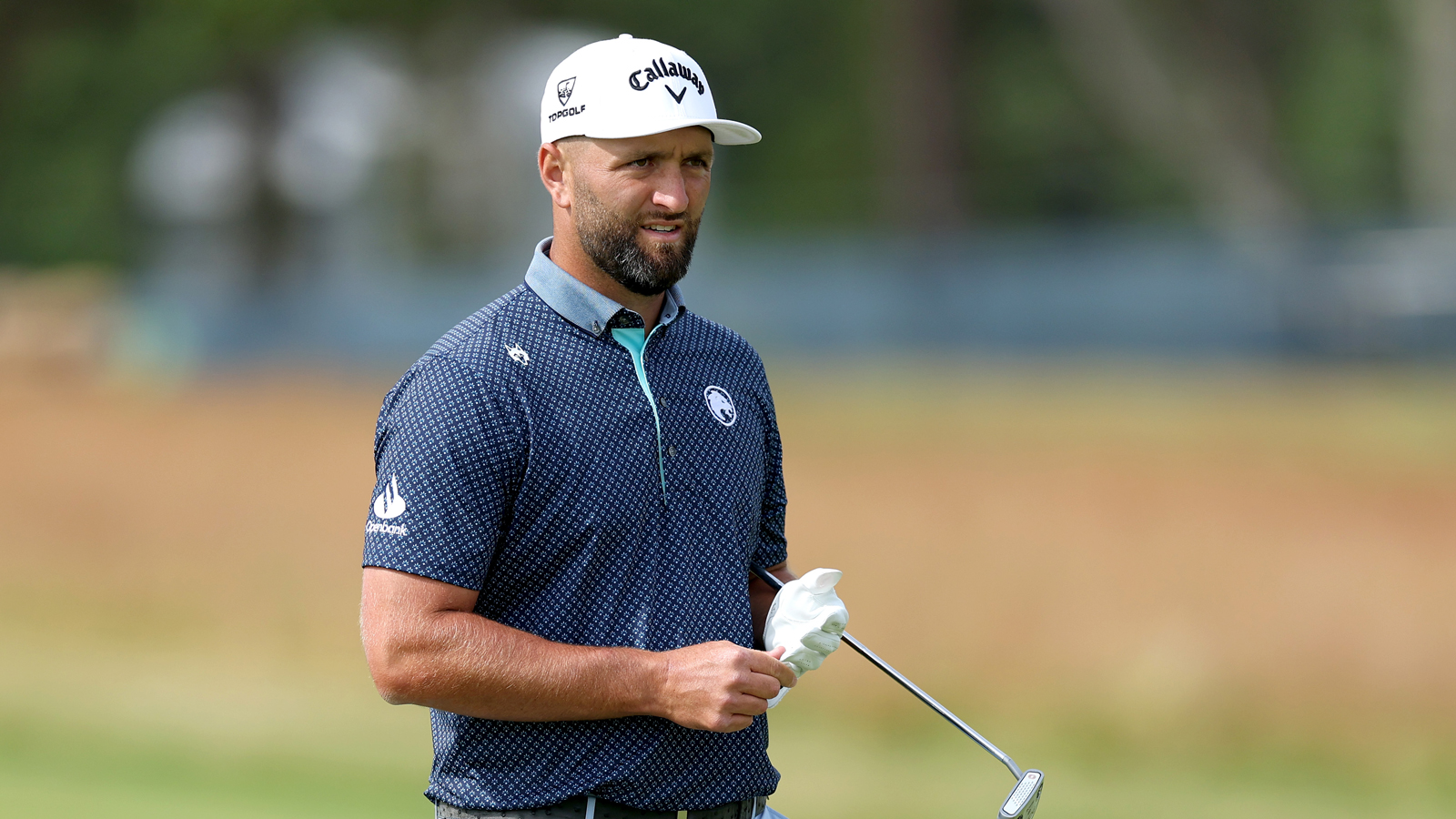 Jon Rahm waits to hit a putt