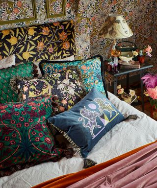 Maximalist bedroom with patterned cushions