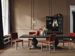 Mid brown dining room with rust velvet dining chairs