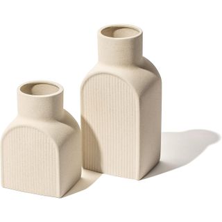 two ceramic vases of different heights with a ribbed design
