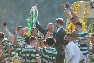 Celtic players celebrate with manager Ange Postecoglou after winning the Scottish Cup in June 2023.