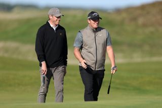 Shinkwin walks with his playing partner at the Old Course