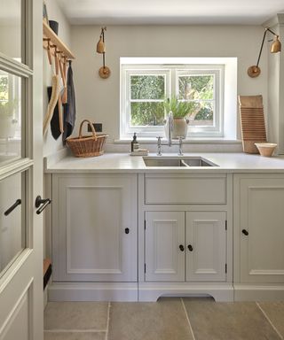 small laundry room with grey painted Shaker units