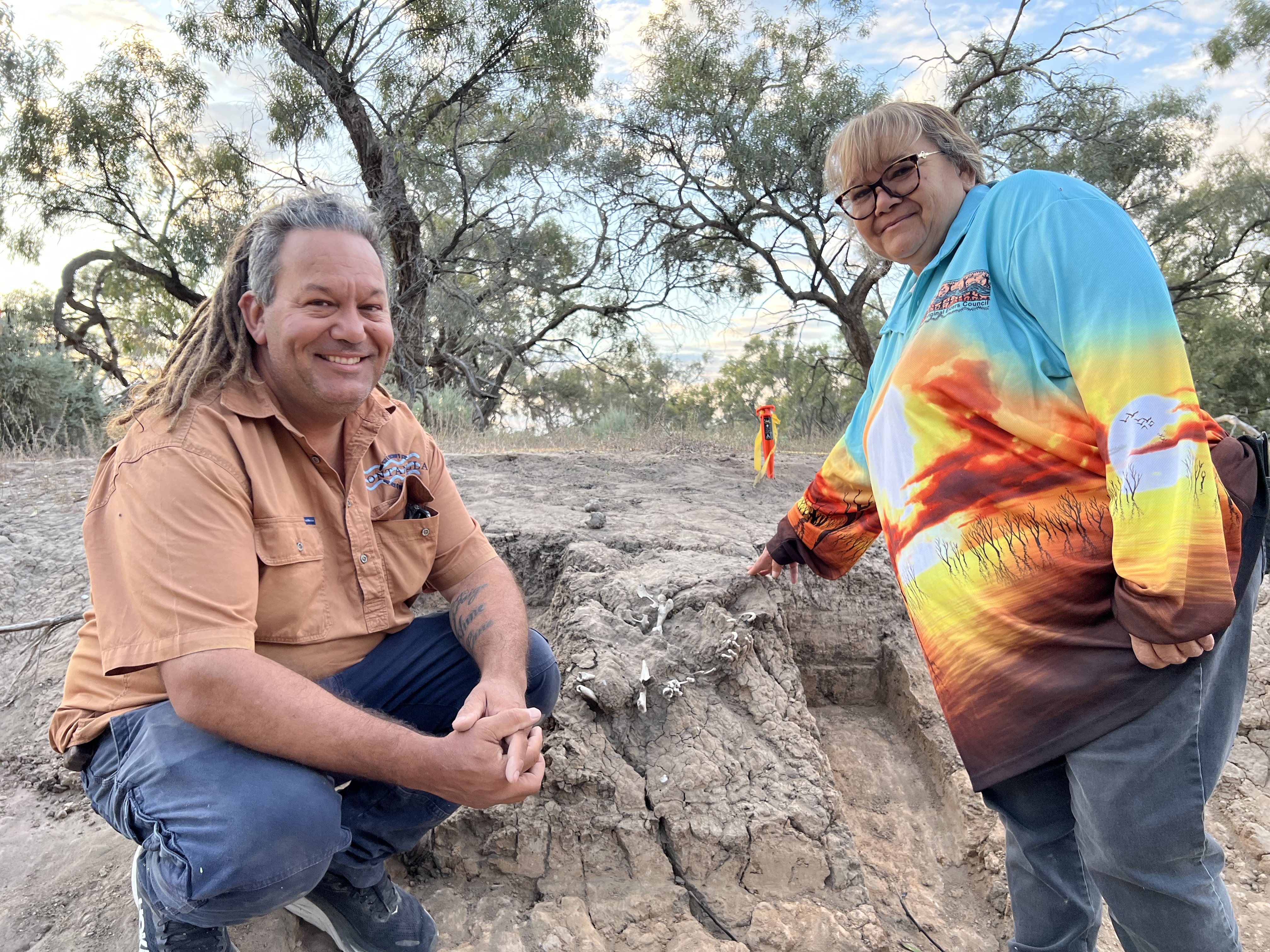 Two Barkindji custodian, Dave Doyle and Barbara Quayle, pose near a dingo burial.