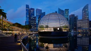 A moody exterior view of Apple Marina Bay Sands at night time