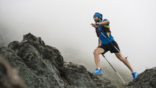 best trail running socks: A trail runner racing through mountains