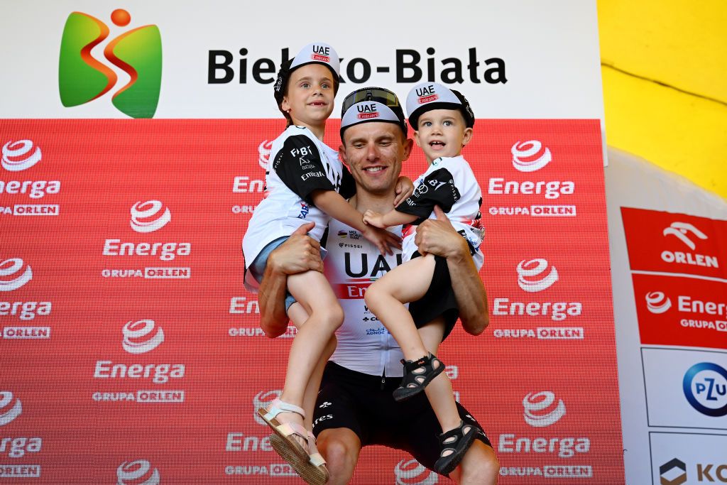 BIELSKOBIALA POLAND AUGUST 02 Rafa Majka of Poland and UAE Team Emirates celebrates at podium as Best Polish Rider Jersey winner with his family during the 80th Tour de Pologne 2023 Stage 5 a 1988km stage from Pszczyna to BielskoBiala 430m UCIWT on August 02 2023 in BielskoBiala Poland Photo by Dario BelingheriGetty Images