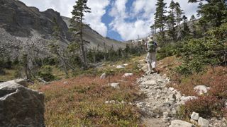 Backpacker hiking Indian Peaks Wilderness Buchanan Pass trail Colorado