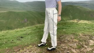 Close up of hiker's legs wearing cream rain pants